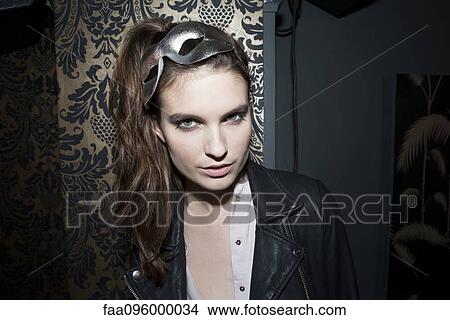 Picture - Woman wearing party mask on head, portrait. Fotosearch