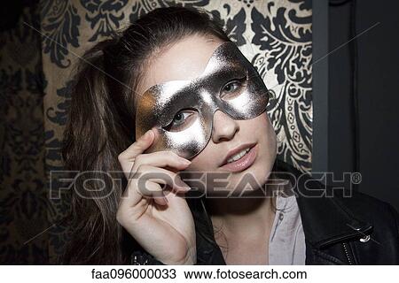 Stock Image - Woman wearing party mask, portrait. Fotosearch