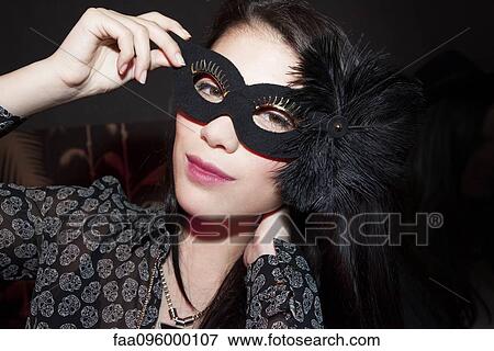 Woman wearing party mask, portrait View Large Photo Image Stock Photo - Woman wearing party mask, portrait. Fotosearch