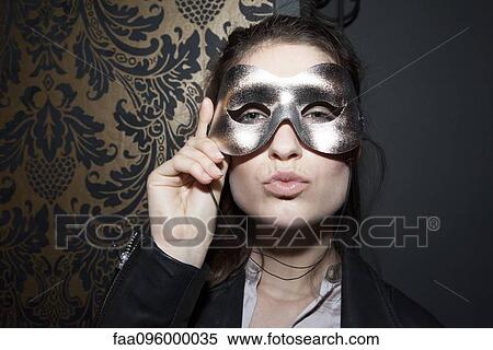 Woman wearing party mask, pursing lips, portrait View Large Photo Image Stock Photography - Woman wearing party mask, pursing lips, portrait. Fotosearch