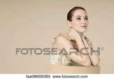 Woman wearing ruffly dress, hair in bun, portrait View Large Photo Image Stock Photography - Woman wearing ruffly dress, hair in bun, portrait. Fotosearch