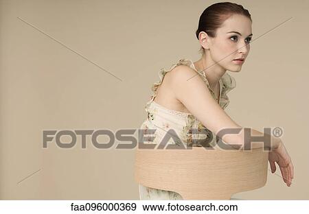 Woman wearing ruffly dress, looking away, portrait View Large Photo Image Stock Photo - Woman wearing ruffly dress, looking away, portrait. Fotosearch