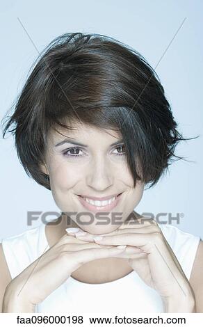 Woman with short hair, hands under chin, smiling, portrait View Large Photo Image Stock Photo - Woman with short hair, hands under chin, smiling, portrait. Fotosearch