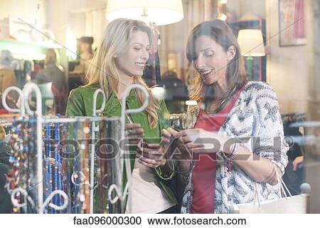 Women shopping in clothing retail store View Large Photo Image Stock Image - Women shopping in clothing retail store. Fotosearch