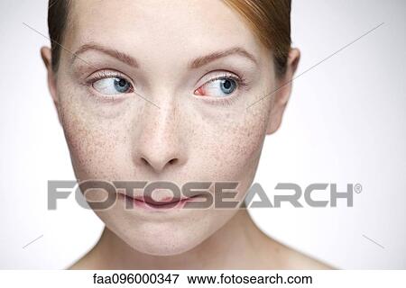 Young woman biting lips View Large Photo Image Stock Photo - Young woman biting lips. Fotosearch