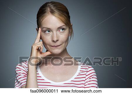 Stock Image - Young woman contemplating. Fotosearch