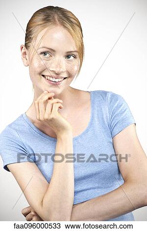 Stock Image - Young woman daydreaming, portrait. Fotosearch