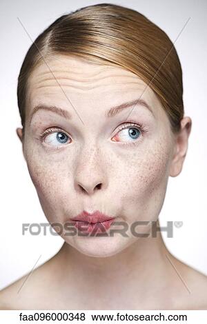 Stock Photo - Young woman pursing lips. Fotosearch