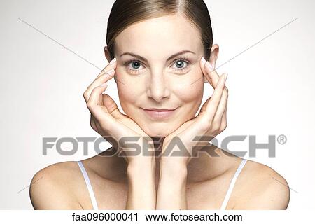Young woman rubbing temples View Large Photo Image Stock Image - Young woman rubbing temples. Fotosearch