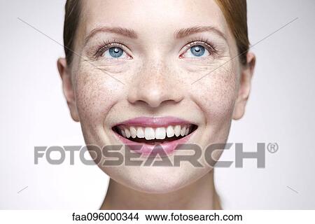 Young woman smiling, looking away View Large Photo Image Picture - Young woman smiling, looking away. Fotosearch