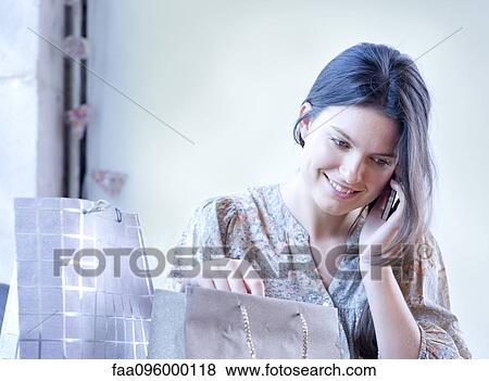Young woman using cell phone for phone call View Large Photo Image Stock Photo - Young woman using cell phone for phone call. Fotosearch