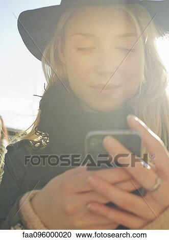 Young woman using smartphone View Large Photo Image Stock Image - Young woman using smartphone. Fotosearch