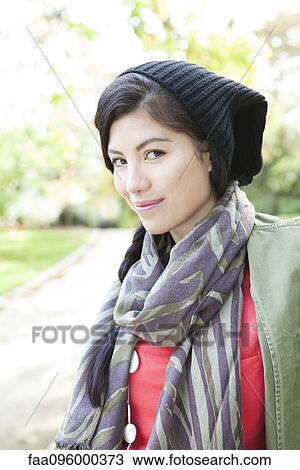 Young woman wearing knit hat and scarf, smiling, portrait View Large Photo Image Stock Image - Young woman wearing knit hat and scarf, smiling, portrait. Fotosearch