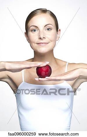 Stock Photo - Young woman with apple. Fotosearch