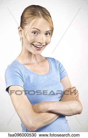 Young woman with arms folded, portrait View Large Photo Image Stock Image - Young woman with arms folded, portrait. Fotosearch