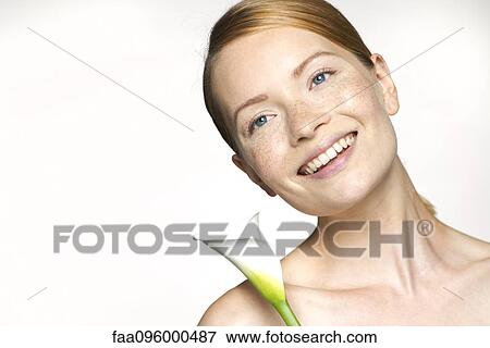 Stock Photo - Young woman with calla lily, portrait. Fotosearch