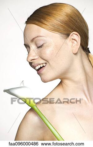 Young woman with calla lily, portrait View Large Photo Image Stock Photograph - Young woman with calla lily, portrait. Fotosearch