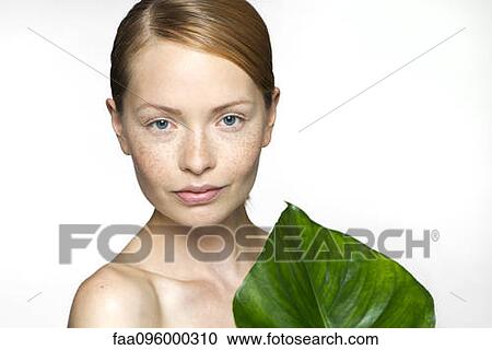 Young woman with tropical plant leaf, portrait View Large Photo Image Stock Image - Young woman with tropical plant leaf, portrait. Fotosearch