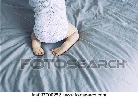 Baby on bed View Large Photo Image Stock Image - Baby on bed. Fotosearch