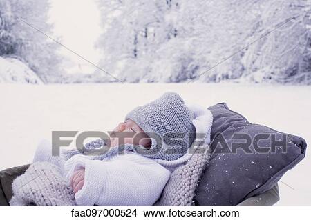 Baby sleeping in bassinet in wintery scane View Large Photo Image Picture - Baby sleeping in bassinet in wintery scane. Fotosearch
