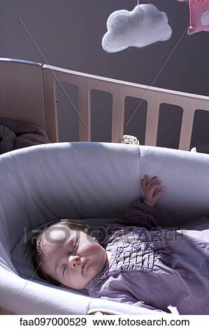 Stock Photo - Baby sleeping in crib. Fotosearch