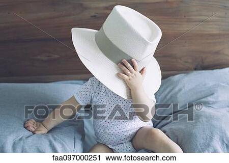 Baby with face obscured by large hat View Large Photo Image Stock Image - Baby with face obscured by large hat. Fotosearch