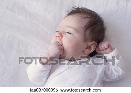 Baby with fingers in mouth View Large Photo Image Stock Photography - Baby with fingers in mouth. Fotosearch