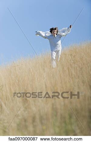 Boy running through tall grass View Large Photo Image Stock Photo - Boy running through tall grass. Fotosearch