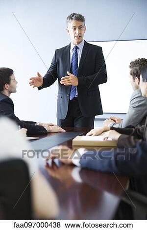 Stock Photo - Business executive giving presentation at meeting. Fotosearch