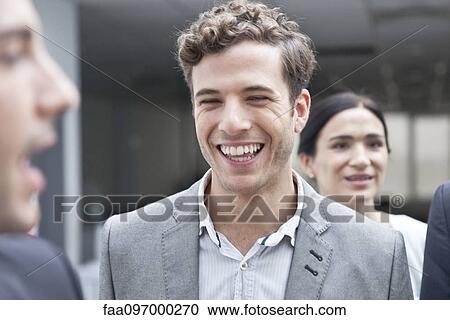 Businessman laughing with colleagues View Large Photo Image Stock Image - Businessman laughing with colleagues. Fotosearch