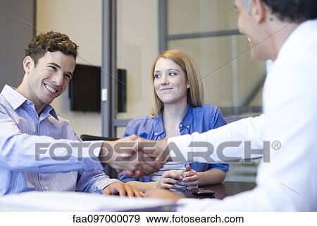 Businessman shaking hands with client in meeting View Large Photo Image Stock Photo - Businessman shaking hands with client in meeting. Fotosearch