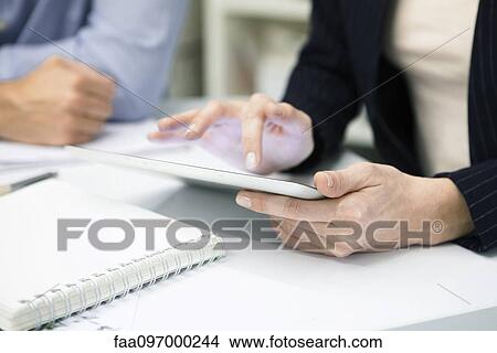Picture - Businesswoman using digital tablet, cropped. Fotosearch
