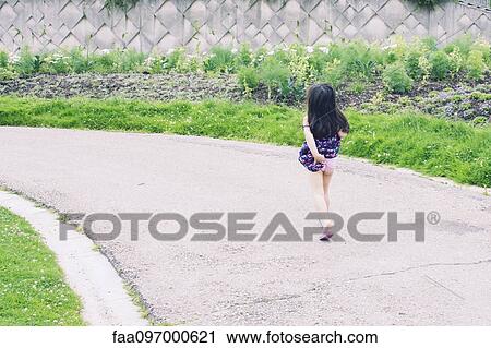 Stock Image - Carefree little girl, rear view. Fotosearch