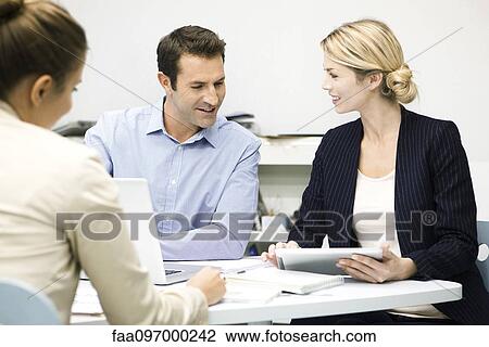 Stock Image - Colleagues working together. Fotosearch