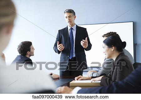 Stock Photo - Corporate trainer leading training session. Fotosearch