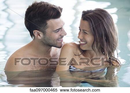 Couple in pool together View Large Photo Image Stock Photography - Couple in pool together. Fotosearch