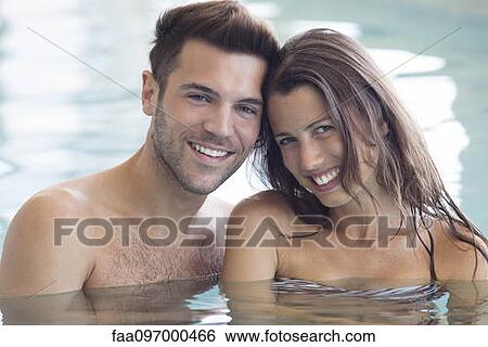 Couple relaxing together in pool, portrait View Large Photo Image Stock Photograph - Couple relaxing together in pool, portrait. Fotosearch