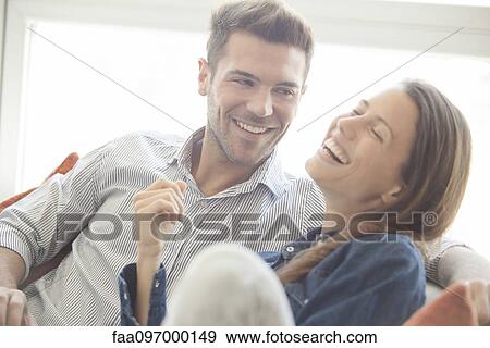 Couple spending lighthearted time together at home View Large Photo Image Stock Photo - Couple spending lighthearted time together at home. Fotosearch