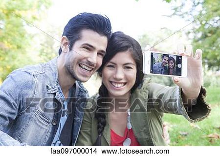Picture - Couple taking self-portrait. Fotosearch
