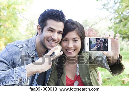 Stock Image - Couple taking self-portrait. Fotosearch