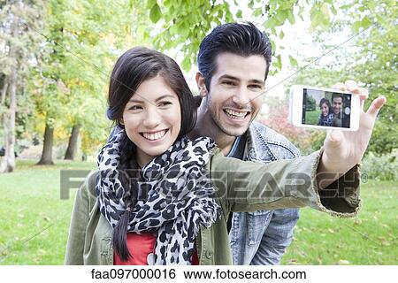 Couple taking self-portrait View Large Photo Image Stock Photograph - Couple taking self-portrait. Fotosearch