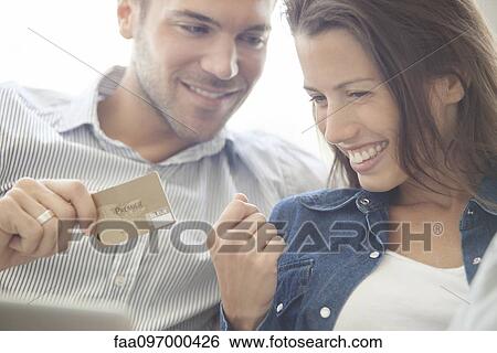 Couple using credit card to shop online View Large Photo Image Stock Photograph - Couple using credit card to shop online. Fotosearch