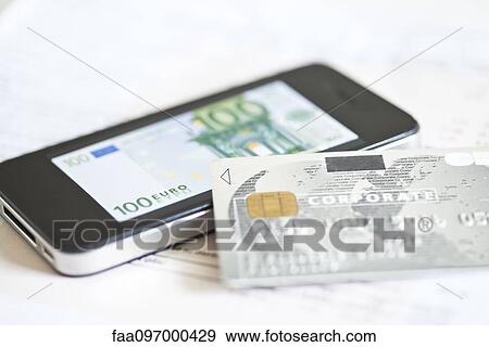 Stock Photo - Credit card resting on smartphone displaying one-hundred euro banknote. Fotosearch