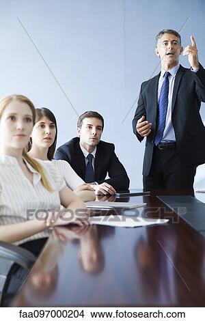 Picture - Executive making presentation at business meeting. Fotosearch