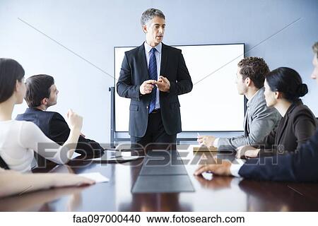 Stock Image - Executive making presentation at business meeting. Fotosearch