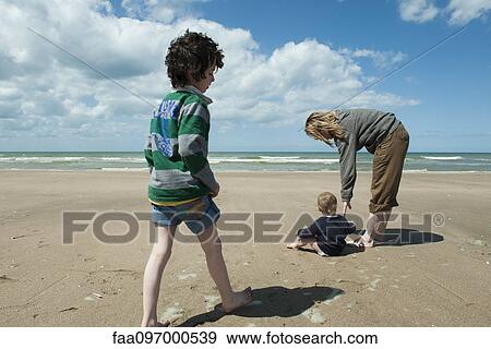 Stock Photo - Family together at the beach. Fotosearch
