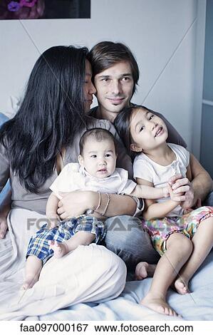 Stock Photo - Family with two children, portrait. Fotosearch