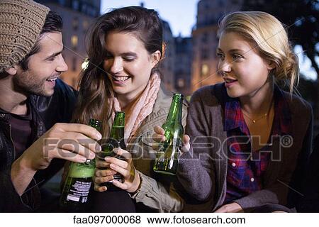 Stock Photo - Friends celebrating outdoors. Fotosearch