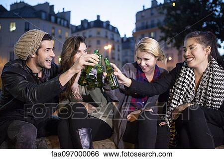 Stock Photograph - Friends celebrating together outdoors. Fotosearch