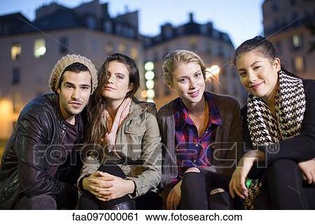Stock Image - Friends hanging out together outdoors. Fotosearch